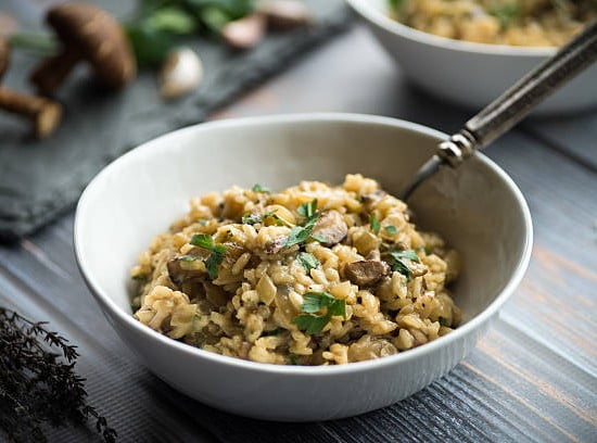 Delicious mushroom risotto with thyme and parsley garnish